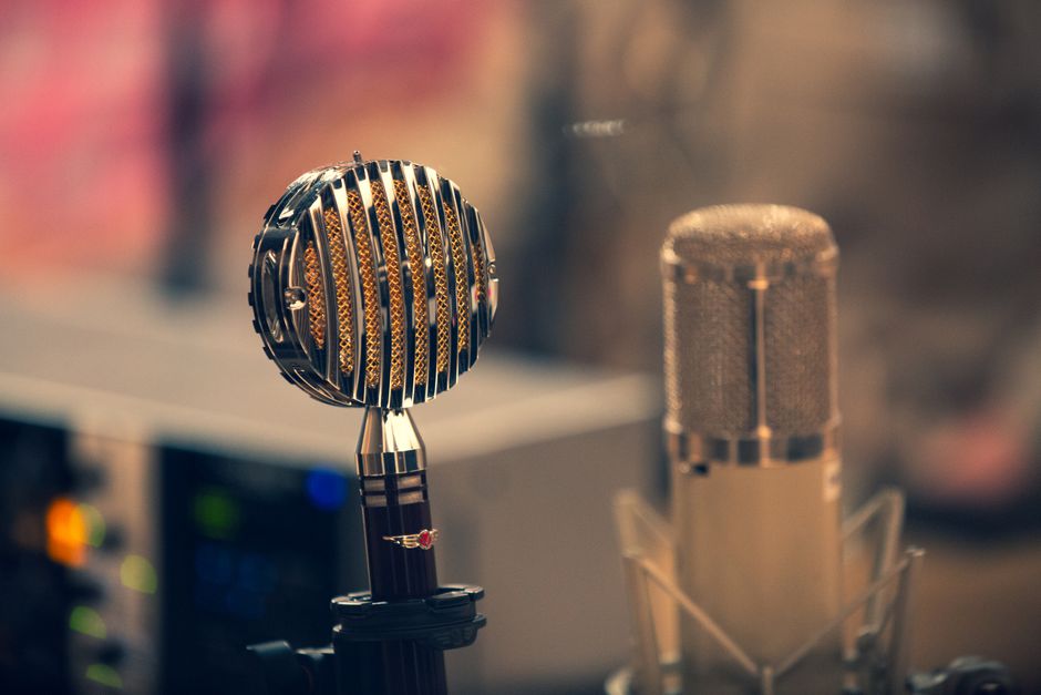 Close-up of vintage and modern microphones in a studio setting, perfect for audio production themes.
